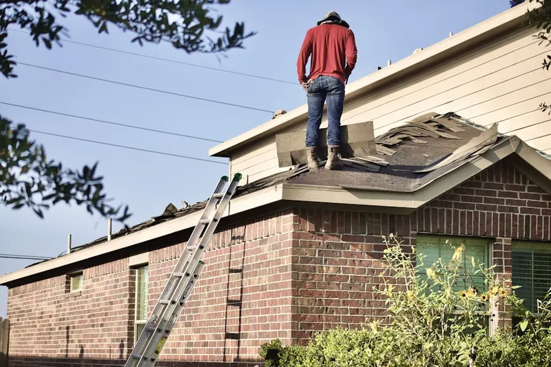Professional roofer working on a residential roof in Saienni Farms